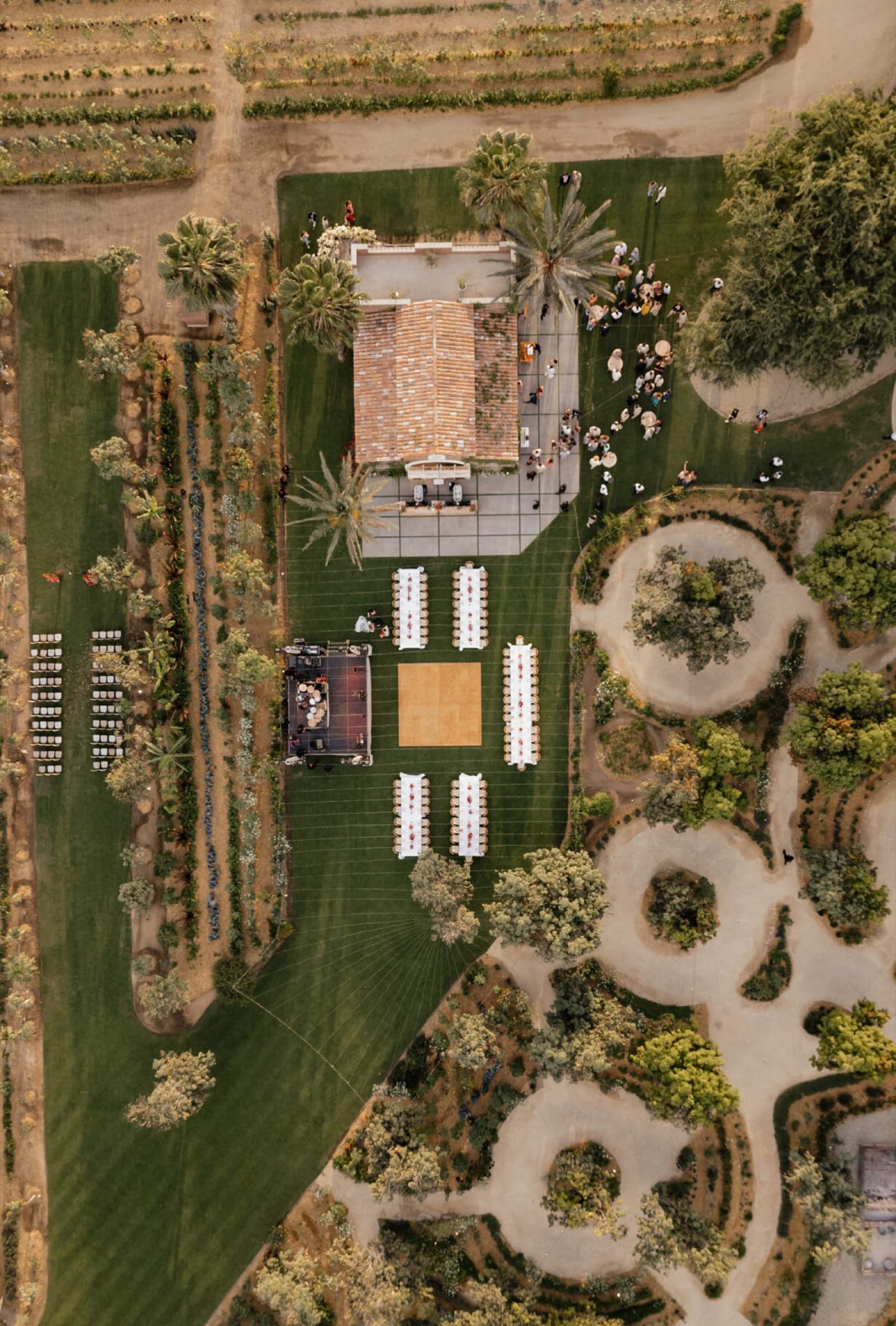 Aerial view of a Flora Farms wedding setup with long banquet tables and a pavilion.